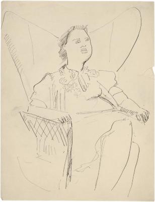 [Seated woman in wingback rocking chair]